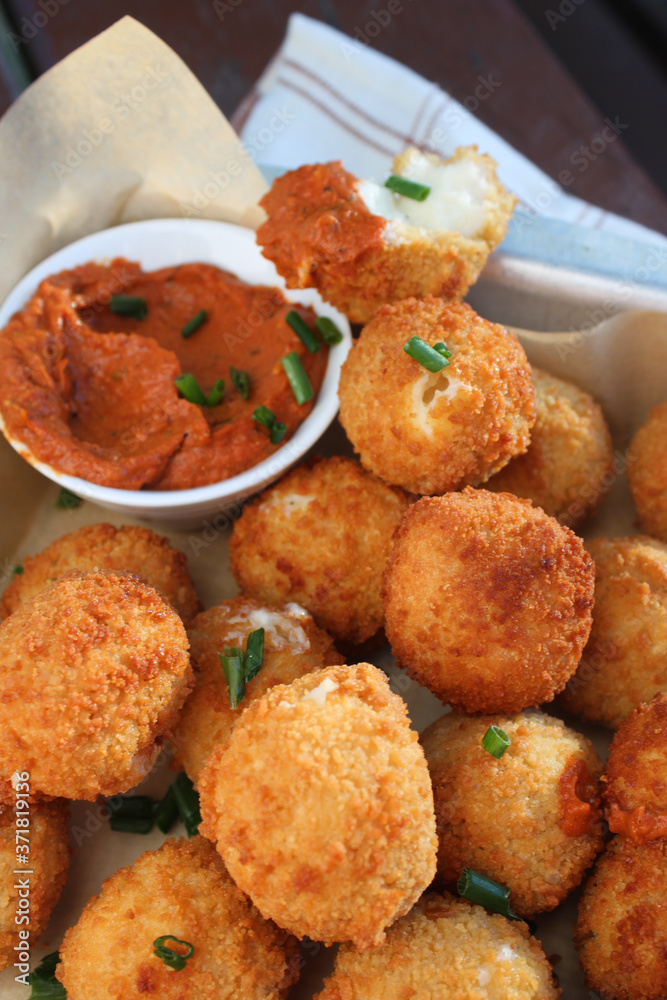 Cheese balls with tomato sauce. Fried snack starter meal. Party food Cheese balls with tomato sauce. Fried snack starter meal. Party food