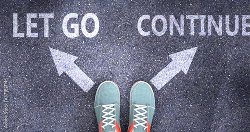 Fotografia Let go and continue as different choices in life - pictured as words Let go, con