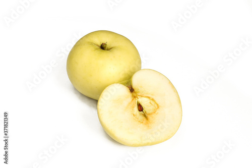 One and a half apple isolated on white background. Yellow fruit sliced