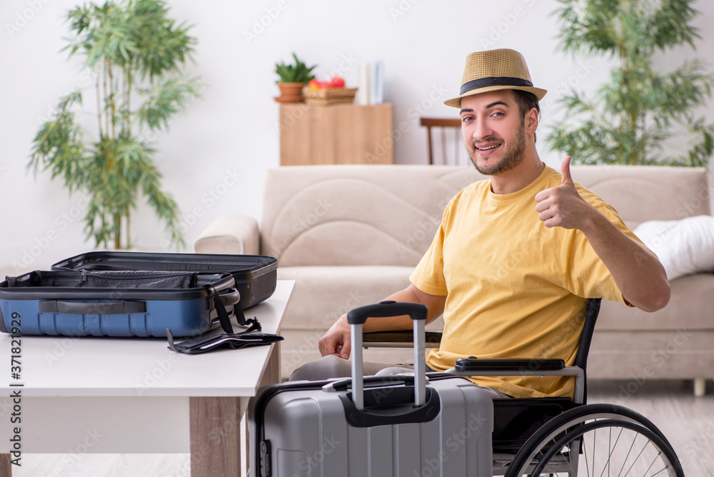 Young man in wheel-chair preparing for departure at home Young man in wheel-chair preparing for departure at home