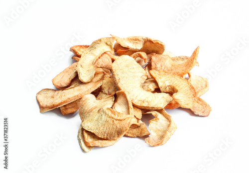 Dried slices of apple isolated on white background. Pile of meal ingredients