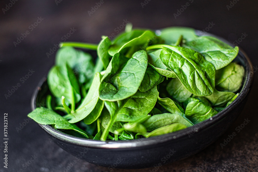 spinach green juicy leaves organic salad serving portion size natural product top view place for text copy space keto or paleo diet raw spinach green juicy leaves organic salad serving portion size natural product top view place for text copy space keto or paleo diet raw