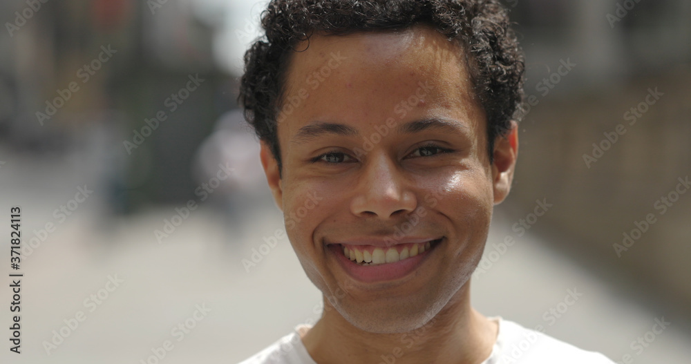 Young Hispanic man in city face portrait smile happy Young Hispanic man in city face portrait smile happy