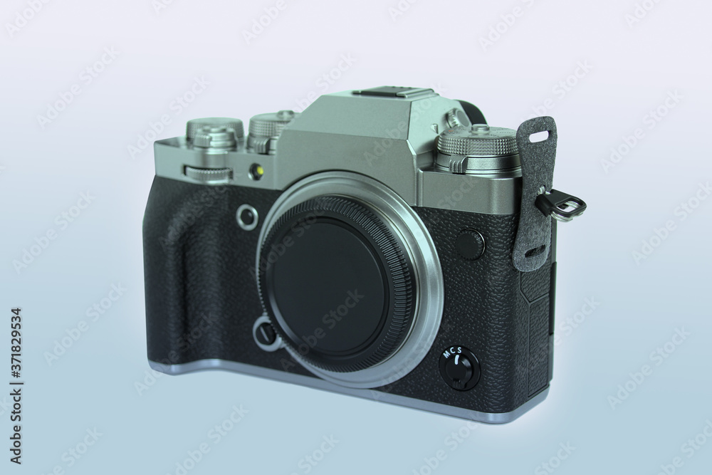 modern mirrorless digital camera in retro style close-up, black, metal, body without a lens on an isolated white background, concept of a professional photographer technique, travel
