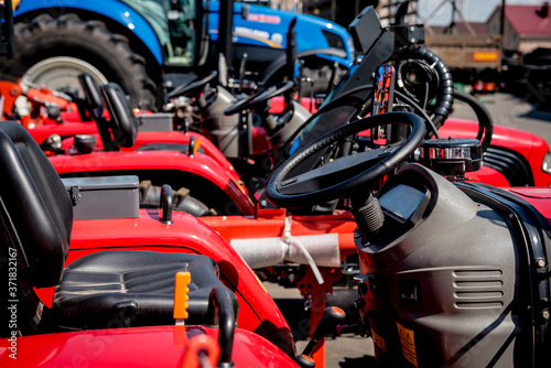 Rows of modern tractors. Industrial details. Agricultural 