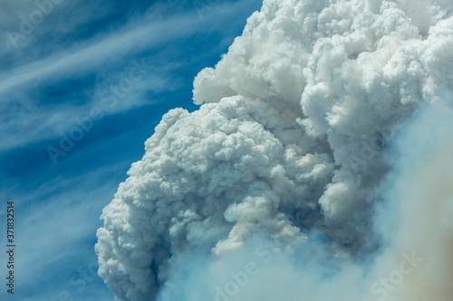 Canvastavla Blue and white sky puffy cumulonimbus clouds and smoke from a large wildfire