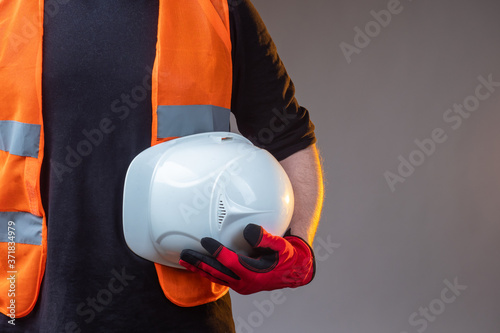 Man holds a helmet in his h...