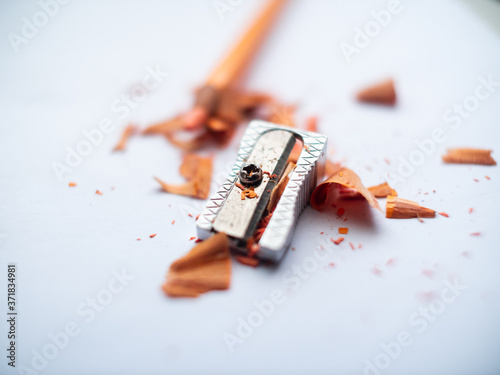 Yellow Pencil next to Sharpener and the Waste on a White Paper - Macro Shot photo