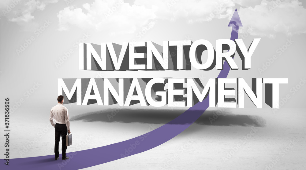 Rear view of a businessman standing in front of INVENTORY MANAGEMENT inscription, successful business concept Rear view of a businessman standing in front of INVENTORY MANAGEMENT inscription, successful business concept