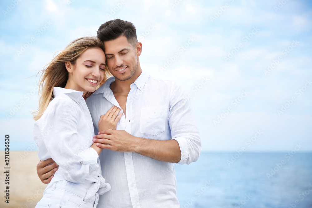 Happy couple on beach, space for text. Romantic walk Happy couple on beach, space for text. Romantic walk