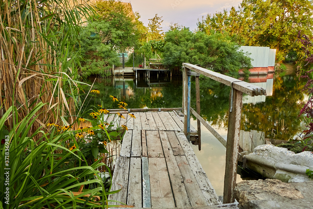 Fototapeta premium Small wooden bridge on small river