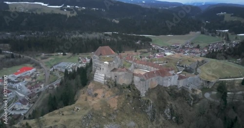 Aerial descending shot, medieval fortification overlooking a mountain pass