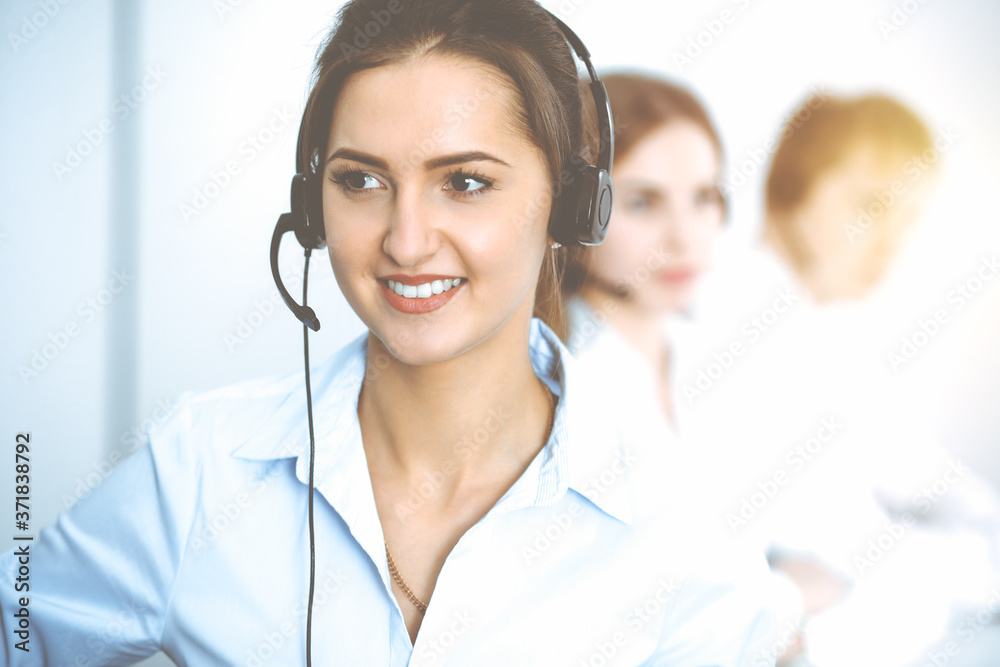 Call center. Focus on beautiful business woman in headset Call center. Focus on beautiful business woman in headset