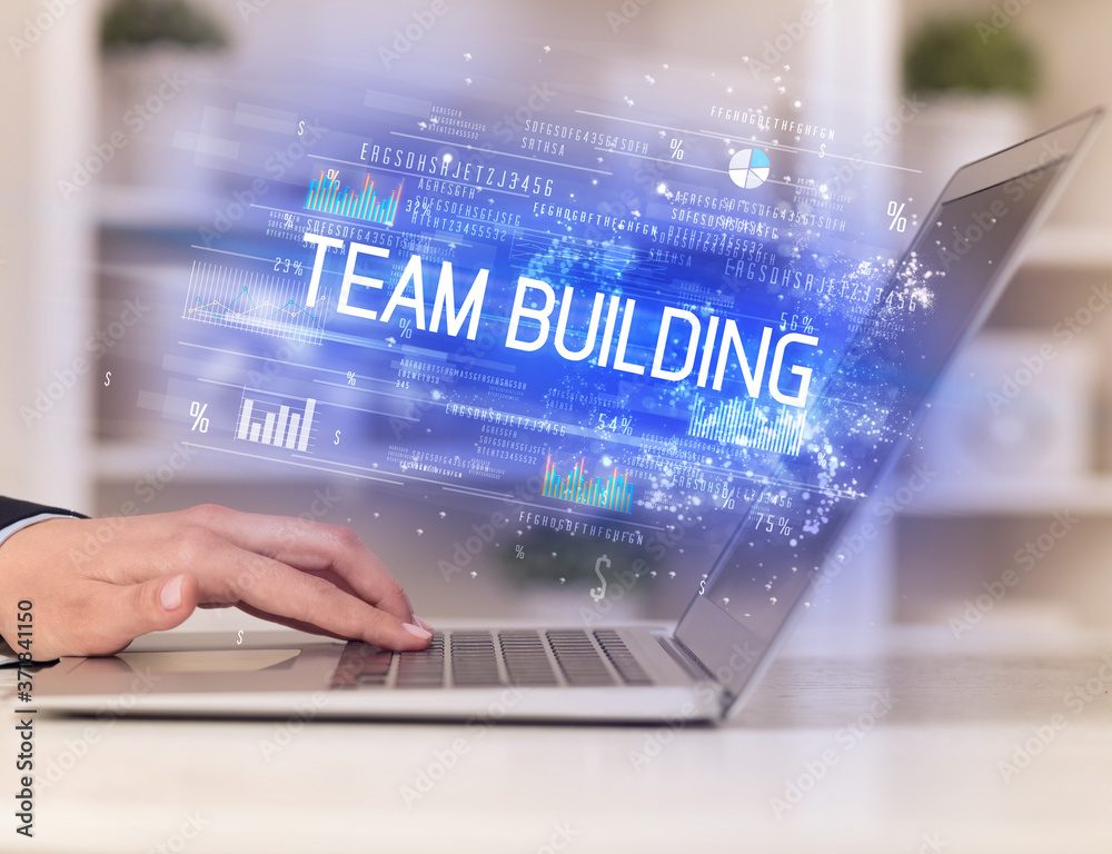 Closeup of businessman hands working on laptop with TEAM BUILDING inscription, succesfull business concept Closeup of businessman hands working on laptop with TEAM BUILDING inscription, succesfull business concept