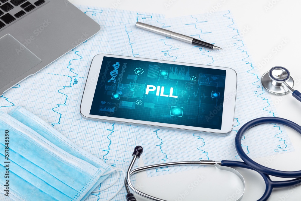 Tablet pc and medical stuff with PILL inscription, prevention concept Tablet pc and medical stuff with PILL inscription, prevention concept