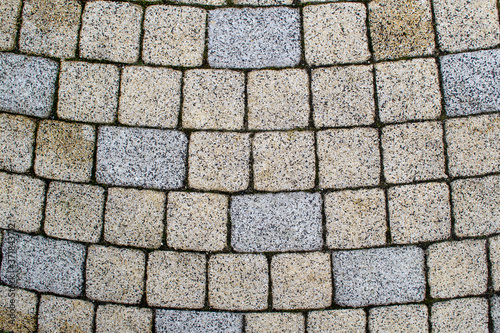 Pavers laid out in a semicircle. Paving squares and rectangles are laid out on the surface.