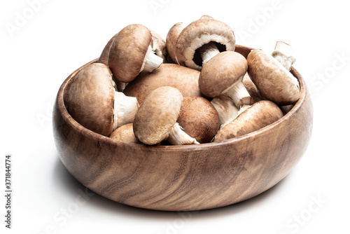 Mushrooms in wooden bowl isolated on white background