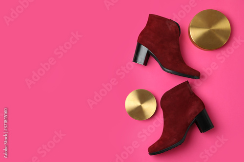 Stylish red female boots and decor on pink background, flat lay. Space for text
