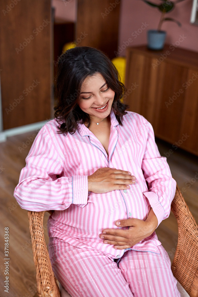 adorable pregnant woman in domestic wear dream to give birth, think and ponders what her future baby will be like. tranquil relaxation. mom to be. adorable pregnant woman in domestic wear dream to give birth, think and ponders what her future baby will be like. tranquil relaxation. mom to be.