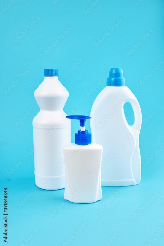 group of blank detergent product bottles over blue background. copy space. cleaning and washing equipment concept group of blank detergent product bottles over blue background. copy space. cleaning and washing equipment concept