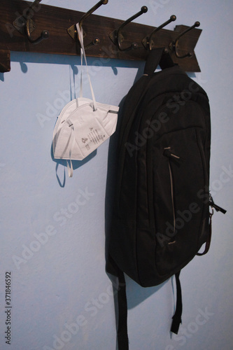 Backpack and covers mouths hung on a clothes rack for the return to school during quarantine.