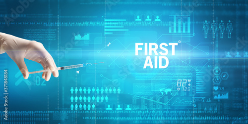 Close-up view of doctor's hand in a white glove holding syringe with FIRST AID inscription, healthcare and medical concept photo