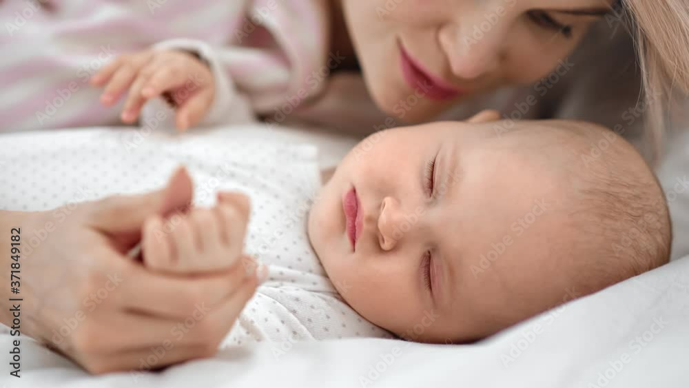 Joyful young mother hugging sleepy little kid talking lovely words. Close up shot on 4k RED camera Joyful young mother hugging sleepy little kid talking lovely words. Close up shot on 4k RED camera