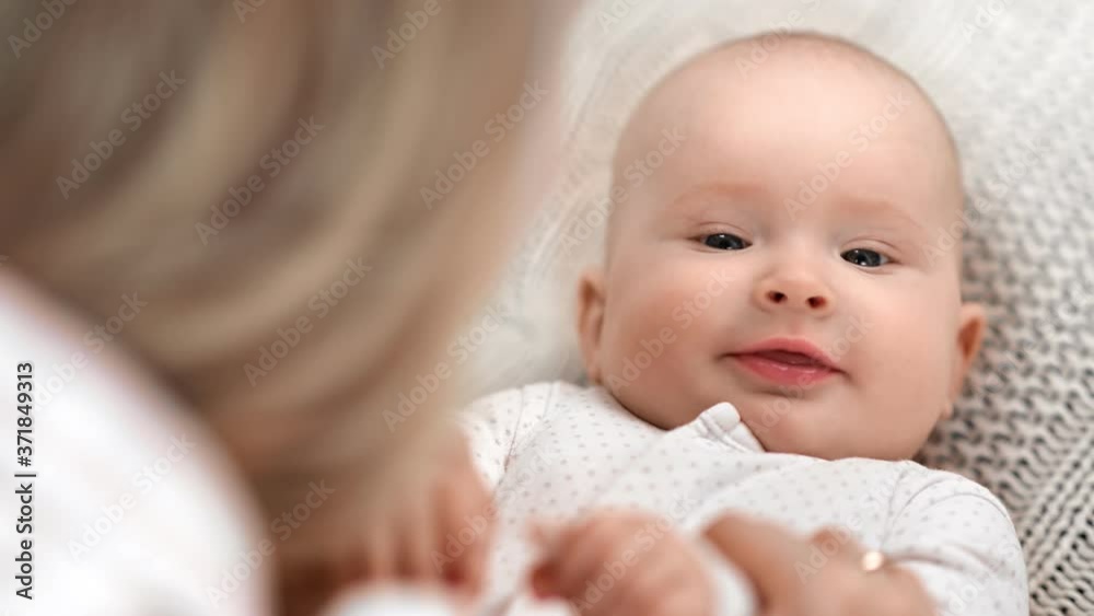 Closeup face of funny cute toddler lying on bed during mother playing. 4k Dragon RED camera Closeup face of funny cute toddler lying on bed during mother playing. 4k Dragon RED camera