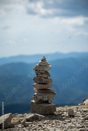 Closeup of stone balance on mountain landscape background