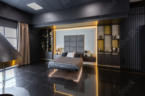 dark modern stylish male apartment interior with lighting, decorative walls, fireplace, dressing area and huge window photo