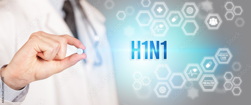 Close-up of a doctor giving you a pill with H1N1 inscription, medical concept Close-up of a doctor giving you a pill with H1N1 inscription, medical concept