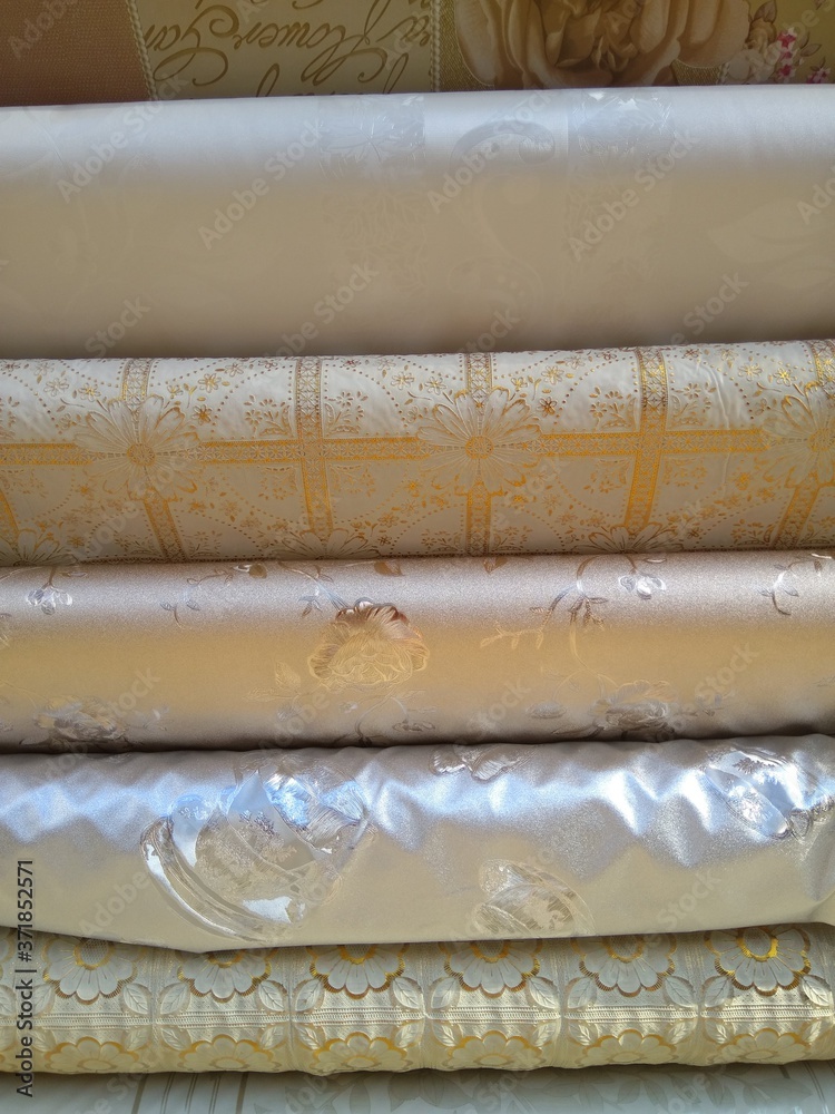 Rolls of beautiful oilcloth on the table close-up. Rolls of beautiful oilcloth on the table close-up.