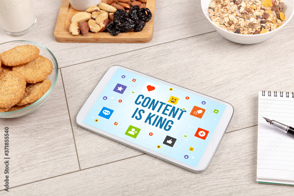 Healthy Tablet Pc compostion with CONTENT IS KING inscription, Social networking concept