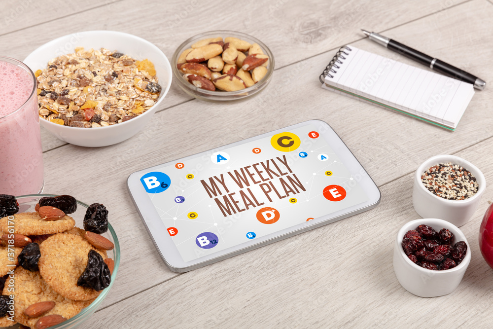Healthy Tablet Pc compostion with MY WEEKLY MEAL PLAN inscription, weight loss concept