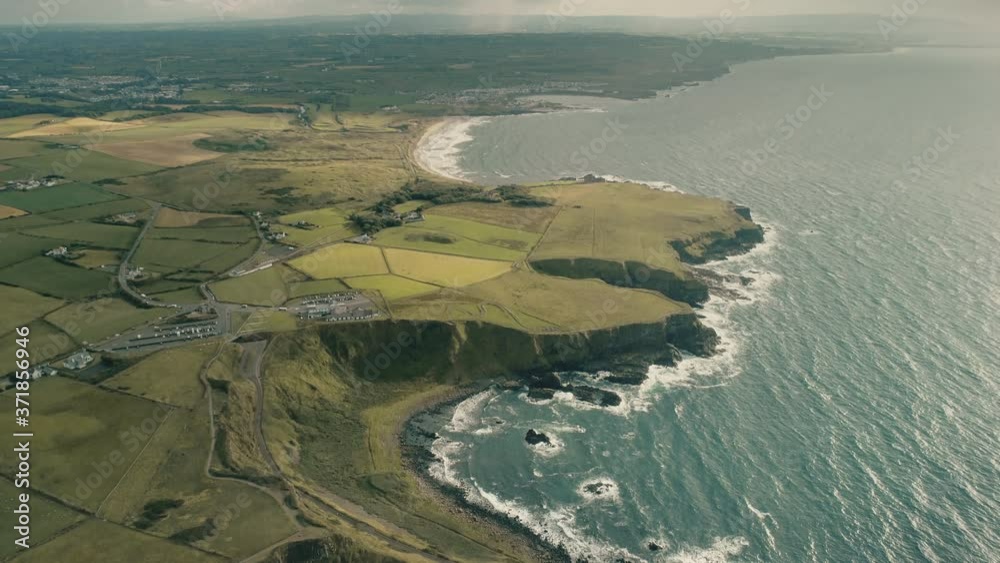 Ireland rural lands aerial ocean cliff shoreline with wide green grass