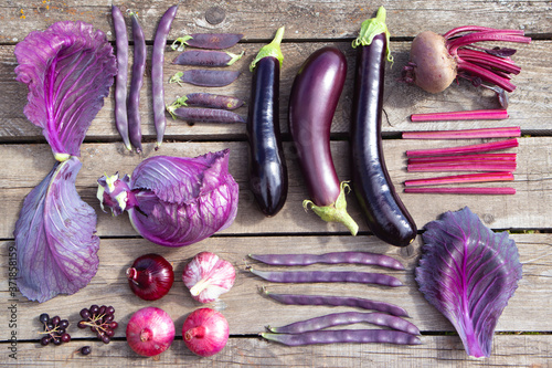 Purple vegetables in knoll style on natural old wooden background. Fashionable concept. Advertising, banner, poster. photo