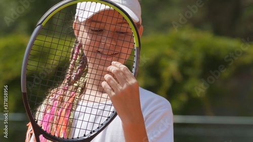 Portrait of a young girl with a tennis racket. © Довидович Михаил