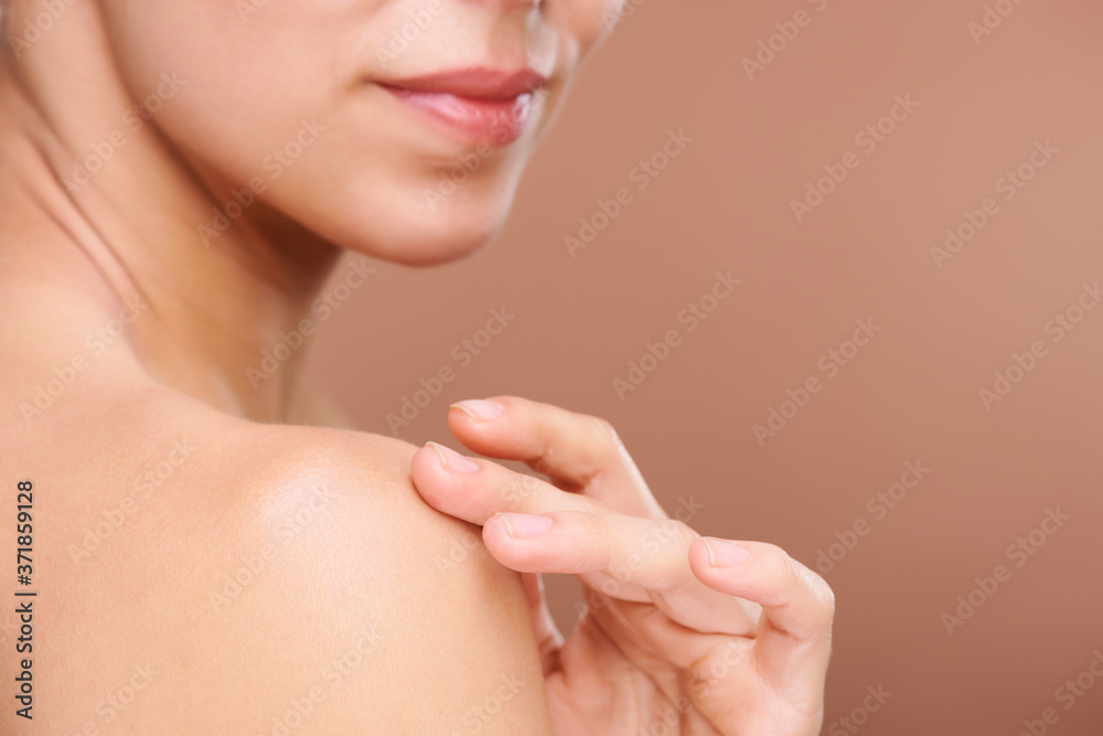 Hand of young healthy woman touching her shoulder while applying cream Hand of young healthy woman touching her shoulder while applying cream
