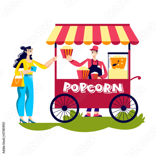 Woman buy popcorn in street kiosk. Young female purchase street food outdors in retro cart