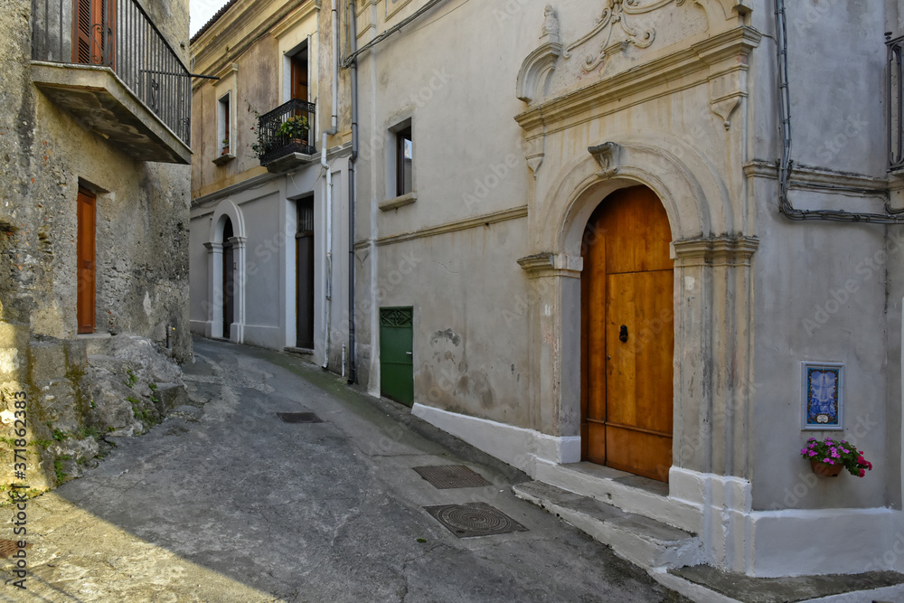 A narrow street between the old houses of San Nicola Arcella, a village in the region of Calabria, Italy. A narrow street between the old houses of San Nicola Arcella, a village in the region of Calabria, Italy.