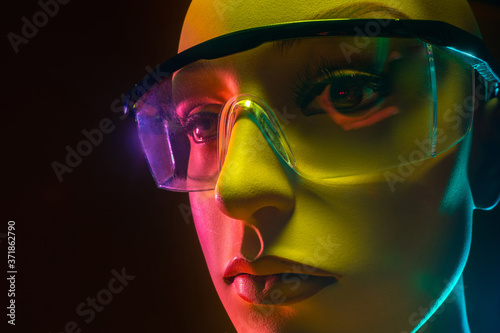 Wallpaper Mural Humanoid robot. Manikin face with glasses. Woman robot face close up. Robotics. Concept - artificial intelligence. Close-up of an artificial intelligence robot head. Creation of robotics. Neon light Torontodigital.ca
