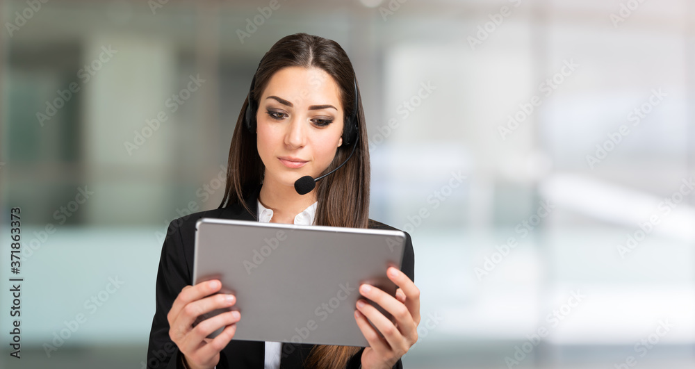 Woman remote meeting using a tablet and headset Woman remote meeting using a tablet and headset