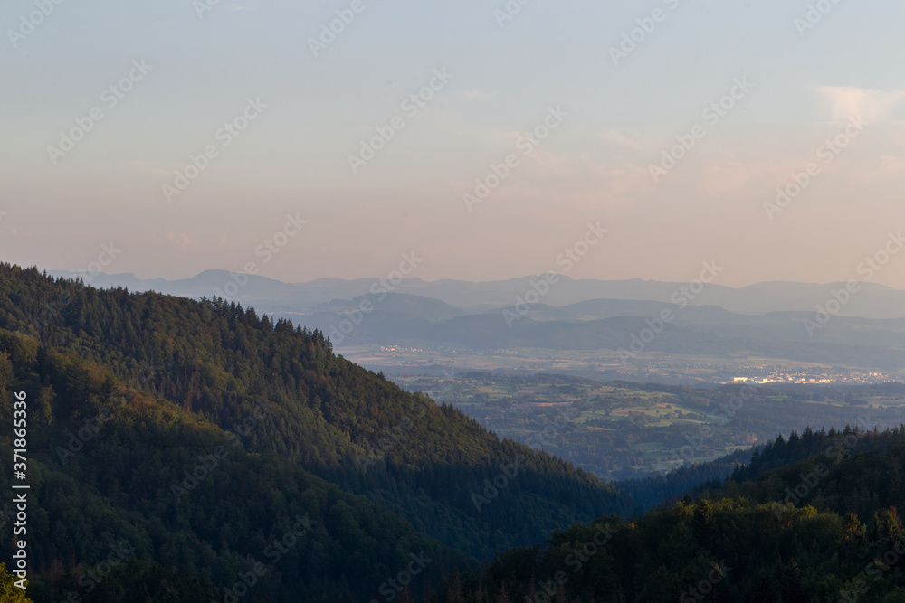 Panorama at sunset from the mountains of the Black Forest near Gersbach over the Wehratal and the city of Wehr towards the Swiss Alps