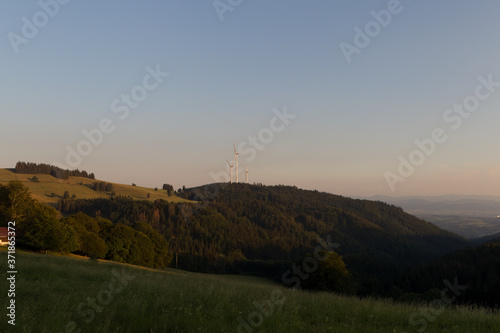 Panorama at sunset from the mountains of the Black Forest near Gersbach over the Wehratal and the city of Wehr towards the Swiss Alps photo