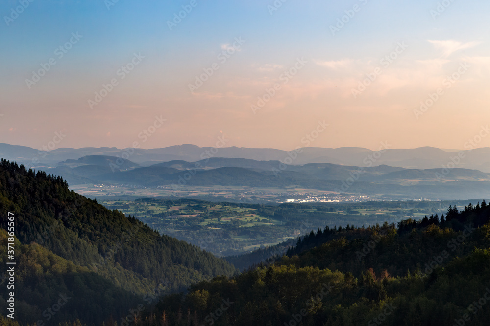 Obraz premium Panorama at sunset from the mountains of the Black Forest near Gersbach over the Wehratal and the city of Wehr towards the Swiss Alps