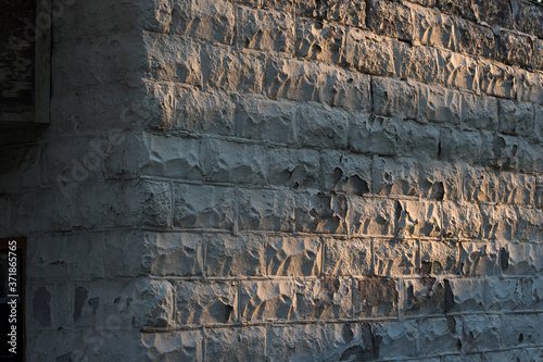Textured Stone Wall at Sunset Background