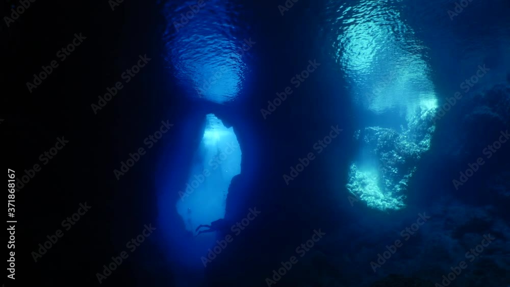cave diving underwater scuba divers exploring caves ocean scenery sun beams and rays background cave diving underwater scuba divers exploring caves ocean scenery sun beams and rays background