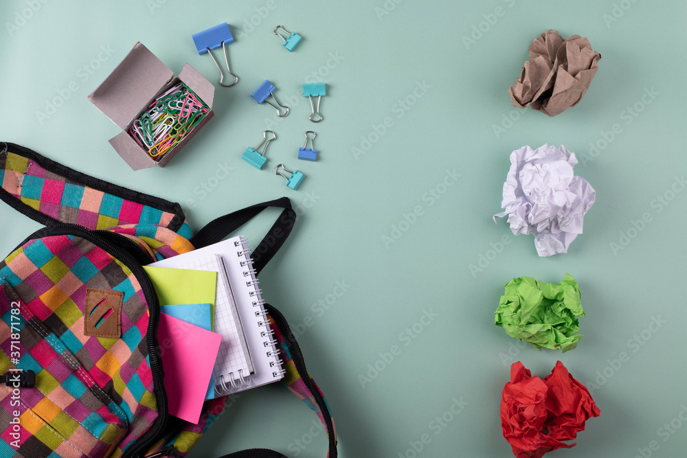 Fototapeta premium different stationary items and notebooks on the blue background. minimalism. flat lay