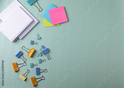 different stationary items and notebooks on the blue background. minimalism. flat lay