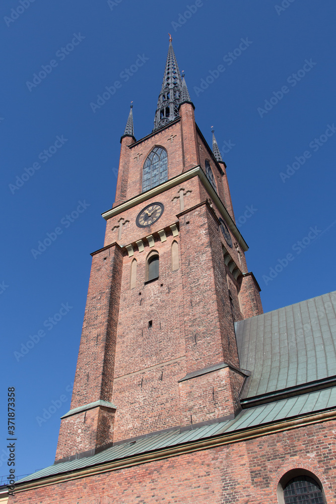 Riddarholmen Church clock tower in a sunny day, Stockholm, Sweden. Riddarholmen Church clock tower in a sunny day, Stockholm, Sweden.
